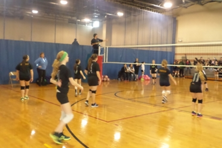 Girls volleyball game in progress.