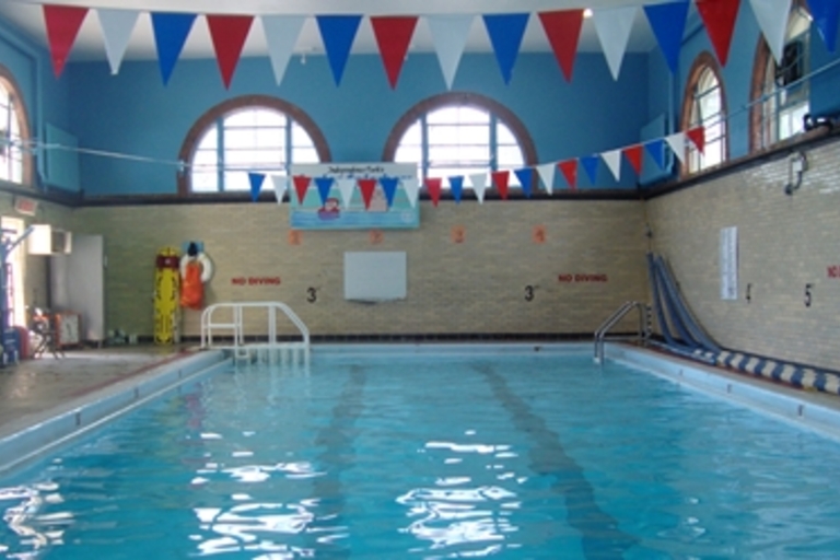 Indoor swimming pool with festive pennant banners.