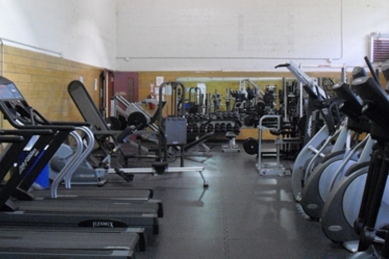 Fitness center with treadmills, elliptical machines, and weight equipment.