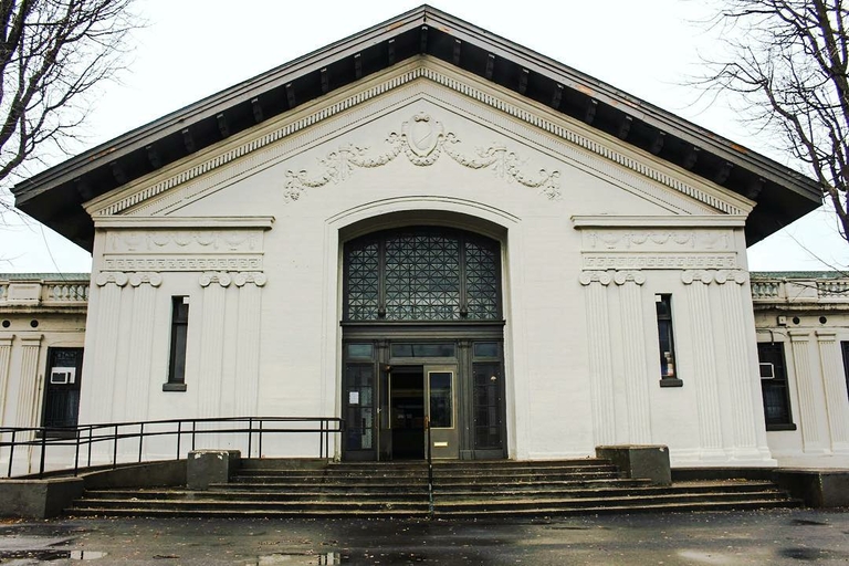 Grand white building with ornate facade and arched entryway.