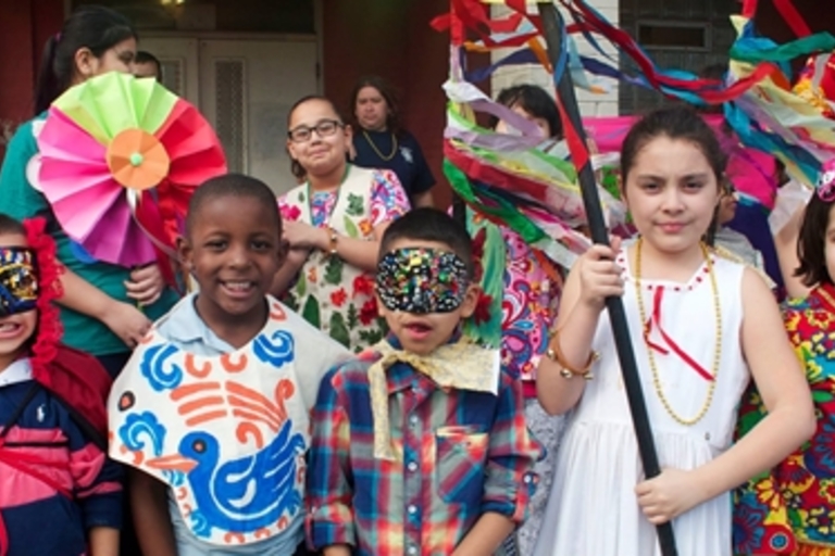 Children in colorful costumes celebrate a cultural festival.

