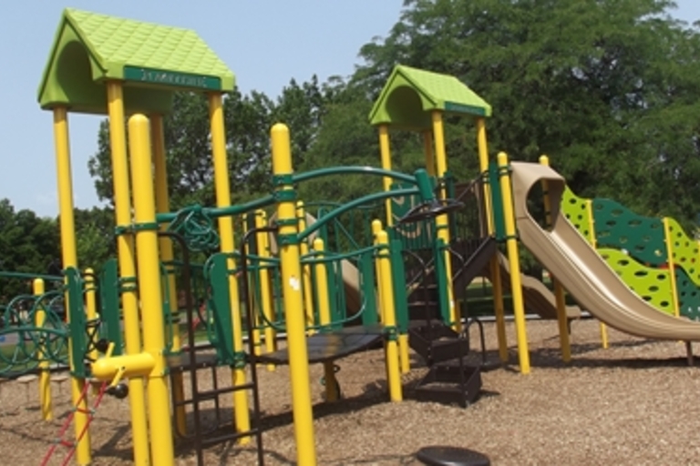 Green and yellow playground structure with slide.
