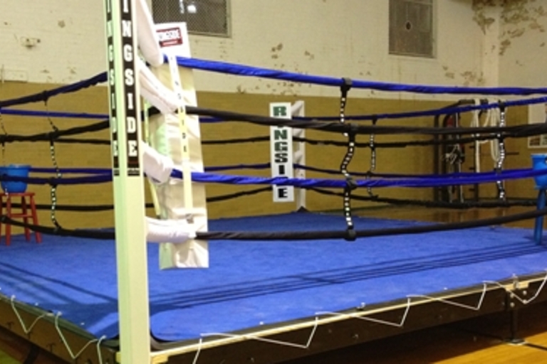 Empty boxing ring with blue canvas.