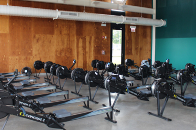 Room full of Concept 2 rowing machines.