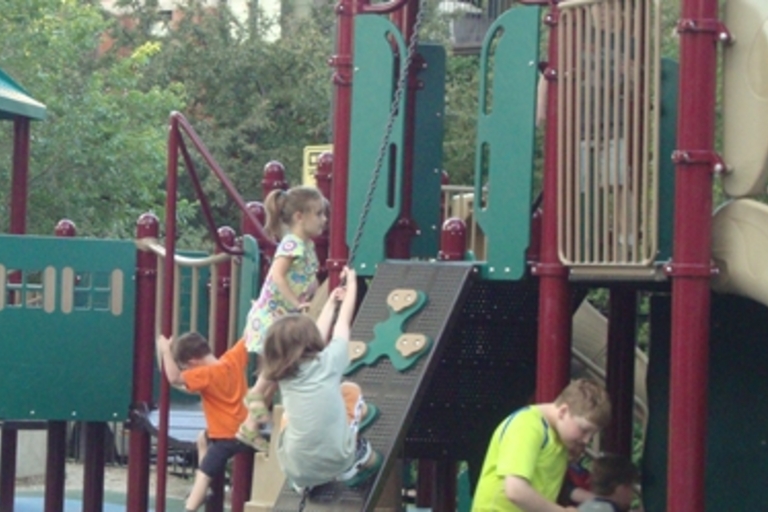 Children playing on a colorful playground.
