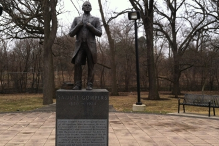Bronze statue of Samuel Gompers in a park.