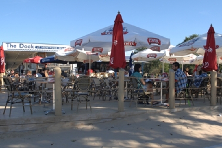 Outdoor patio at The Dock restaurant on a sunny day.