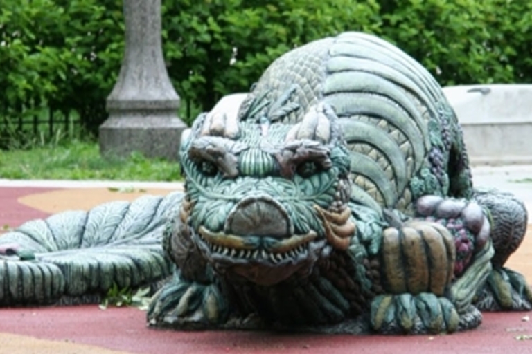 Green dragon sculpture on a playground.