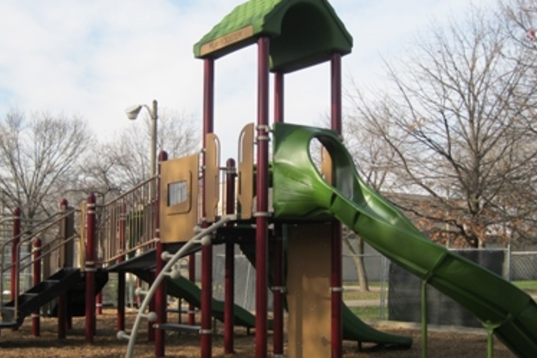Large playground structure with green slide.