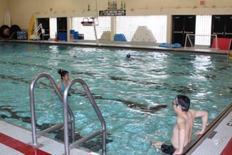 People swimming in an indoor pool.