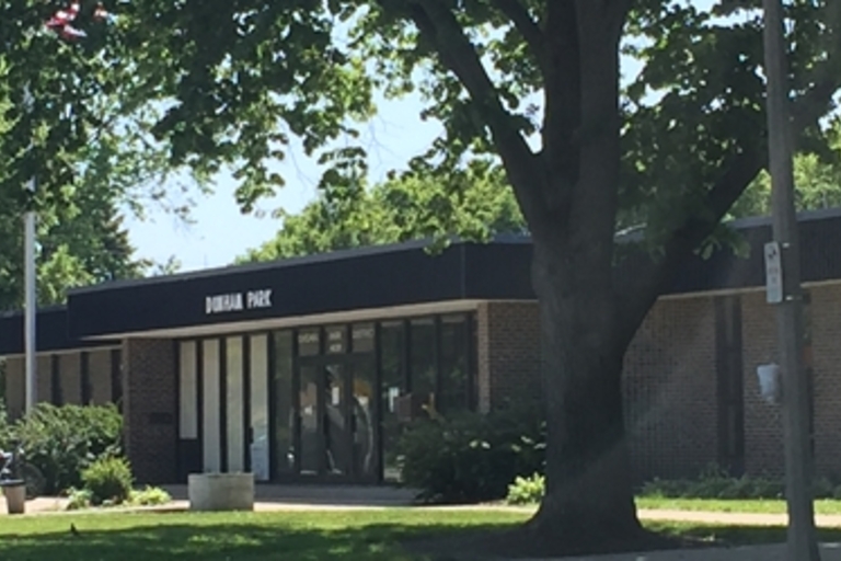 Dunham Park fieldhouse exterior on a sunny day.