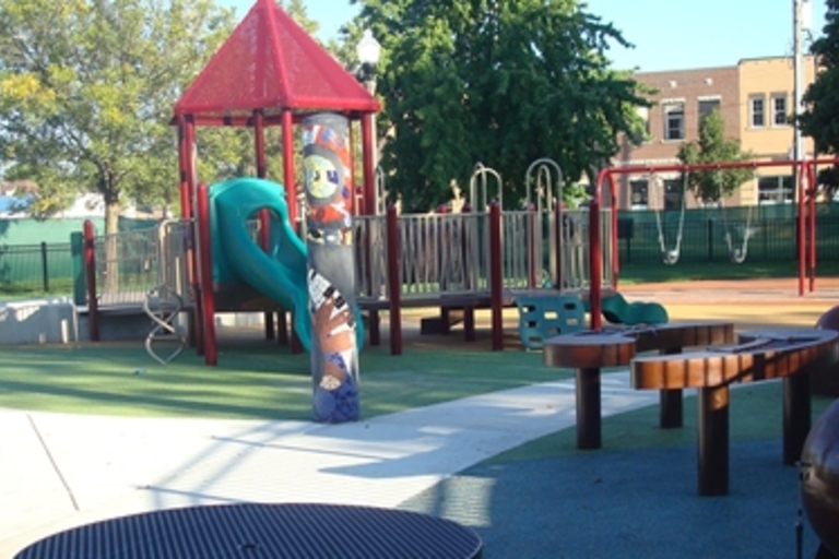 Colorful playground with slides, swings, and musical instruments.
