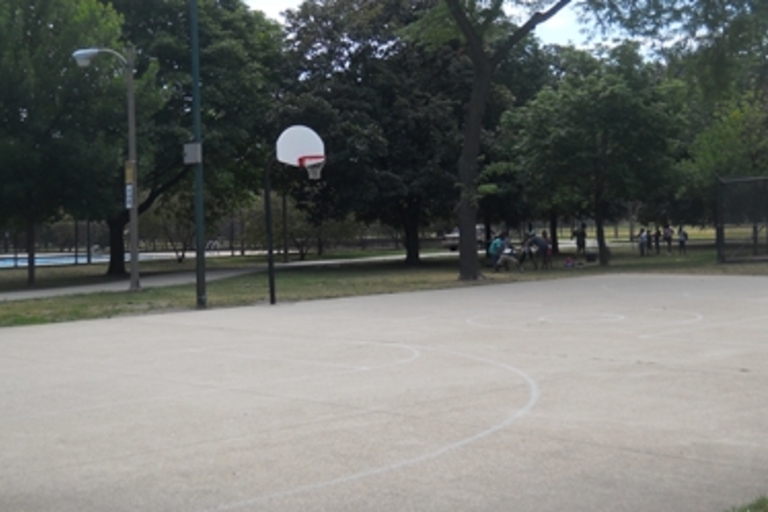 Outdoor basketball court on a sunny day.