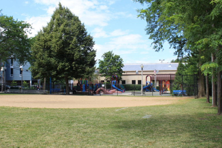 Playground with slides and climbing structures on a sunny day.