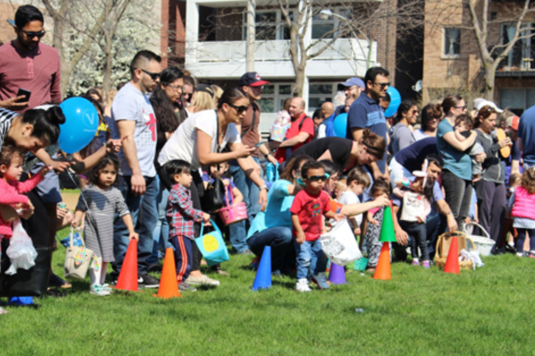 Children and parents line up for an Easter egg hunt.
