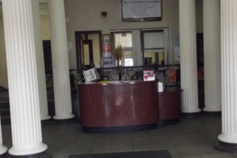 Lobby with white columns and a dark reception desk.