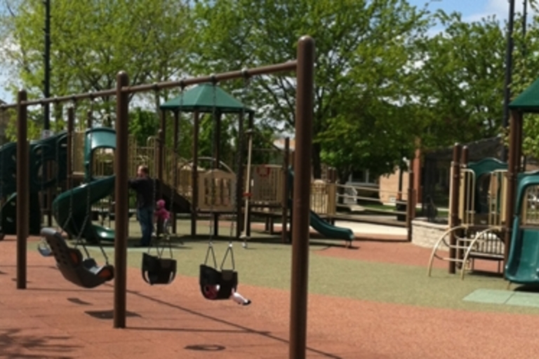 Playground with swings and slides on a sunny day.
