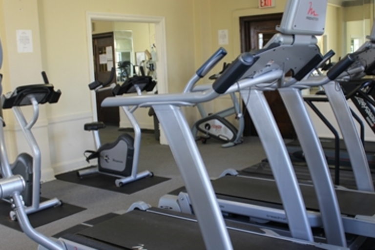 Fitness center with treadmills and stationary bikes.