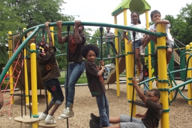 Children play on a colorful playground.
