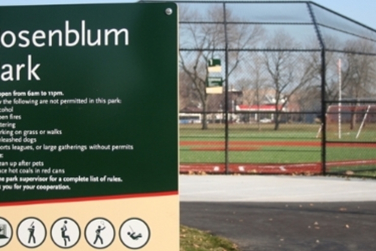 Rosenblum Park sign and baseball field.