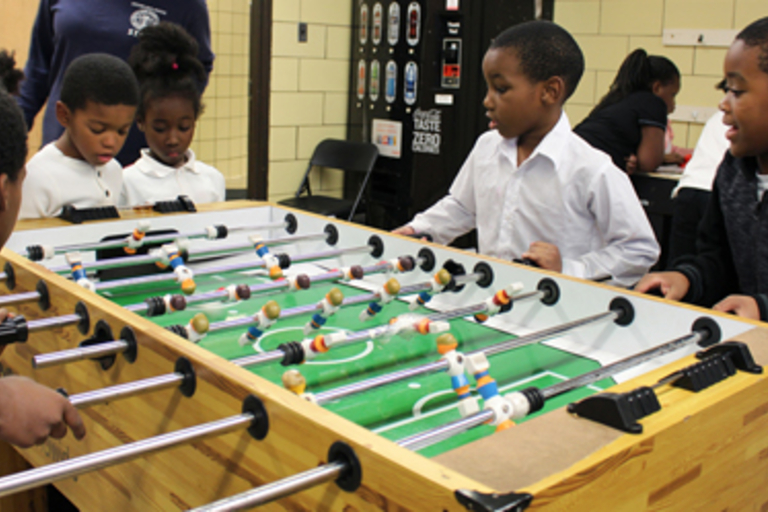 Children play foosball.
