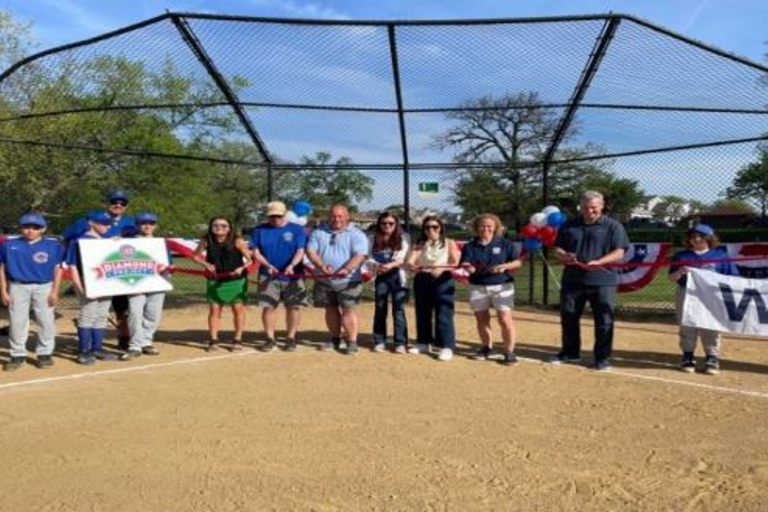 Ribbon-cutting ceremony at a youth baseball field.
