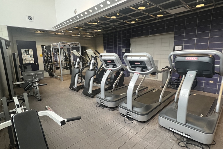 Fitness center with treadmills, ellipticals, and weight machines.