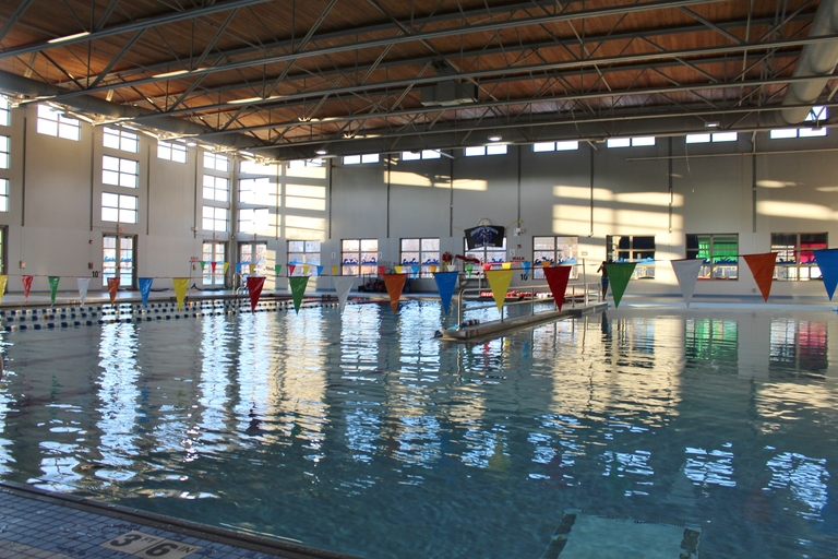 Indoor swimming pool with colorful pennant flags strung across.