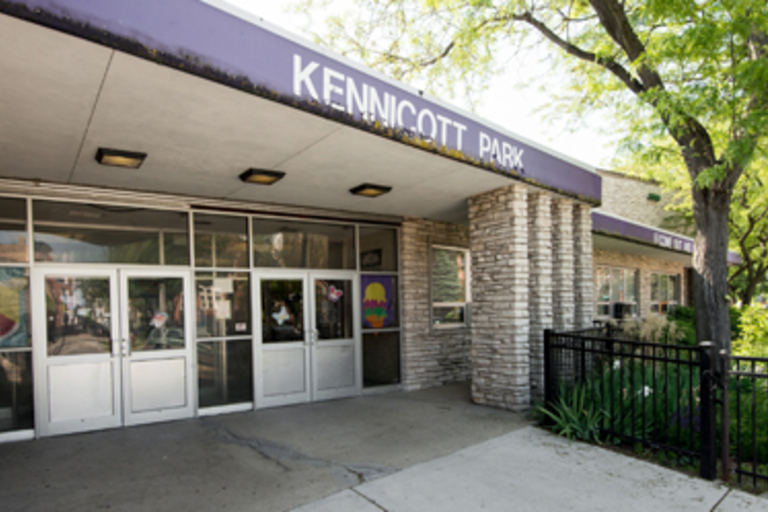 Entrance to Kennicott Park building with glass doors and stone facade.