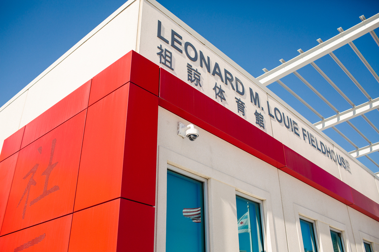 Leonard M. Louie Fieldhouse exterior with red panels and Chinese characters.
