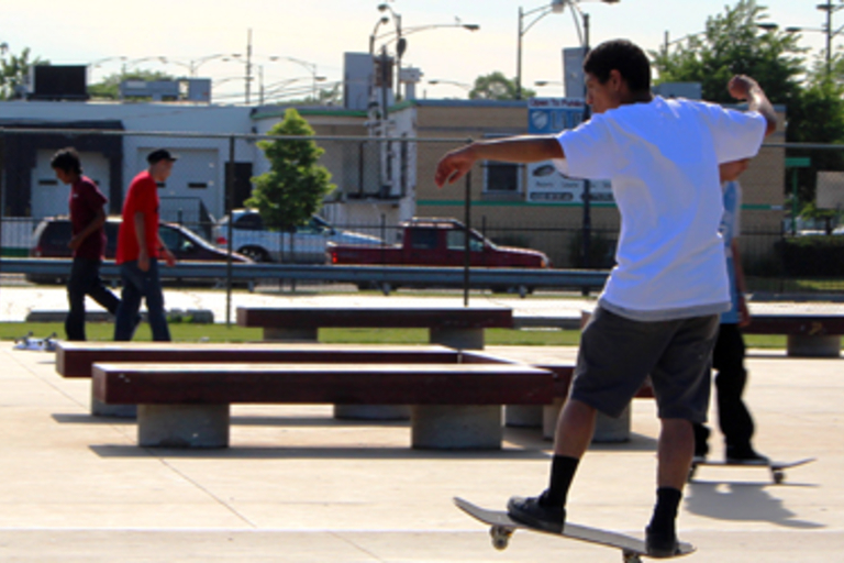 Teenager skateboarding at a skatepark.