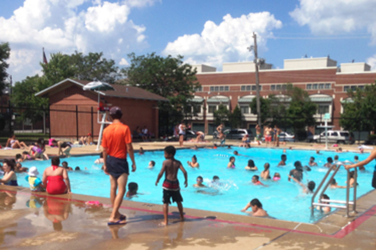 Crowded community pool on a sunny day.
