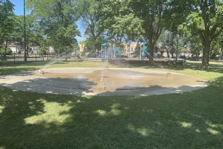 Splash pad spraying water in a park playground.