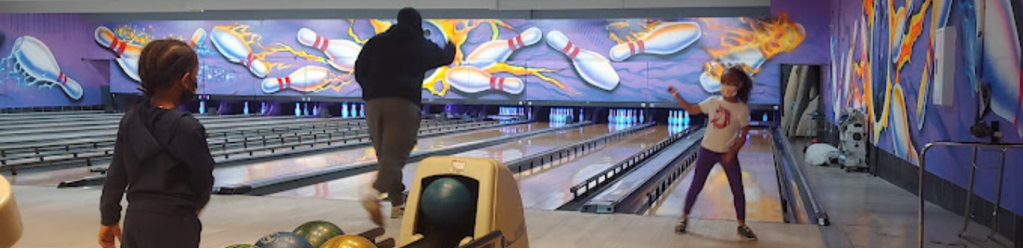 Family bowling at a bowling alley.