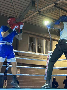 Two boxers sparring in a boxing ring.