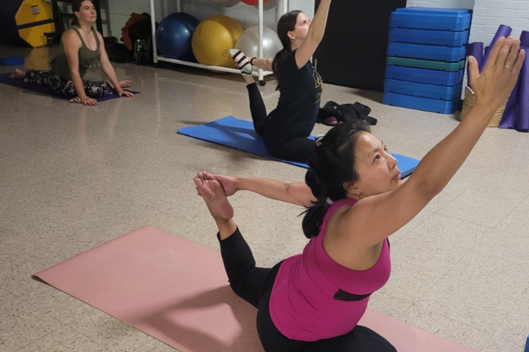 Three women in yoga class.